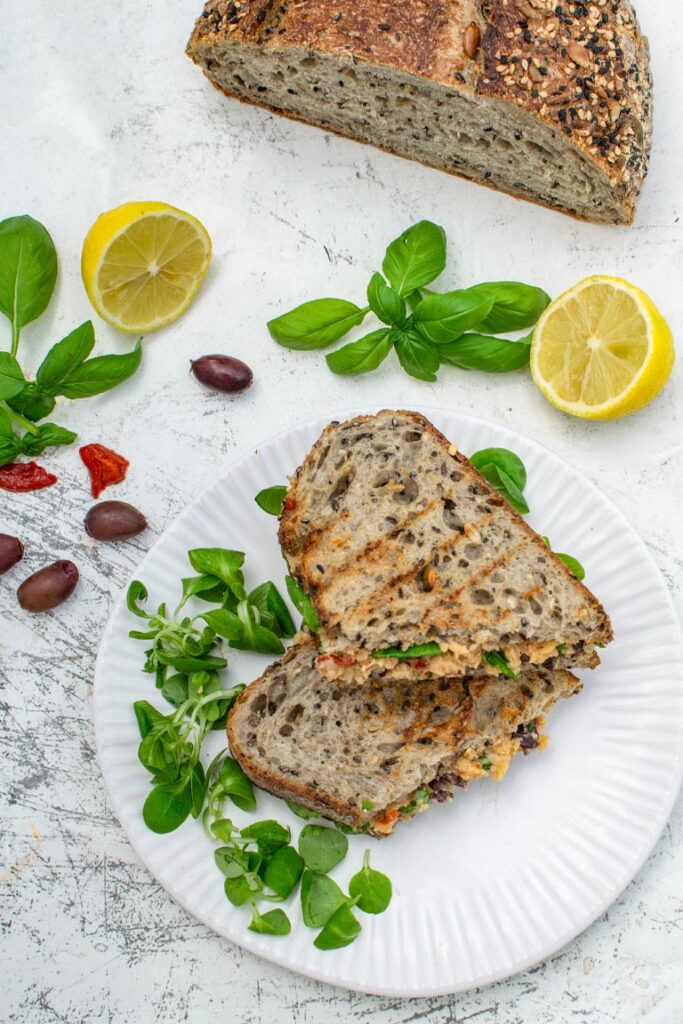 Vegan Mediterranean sandwich served with a side salad