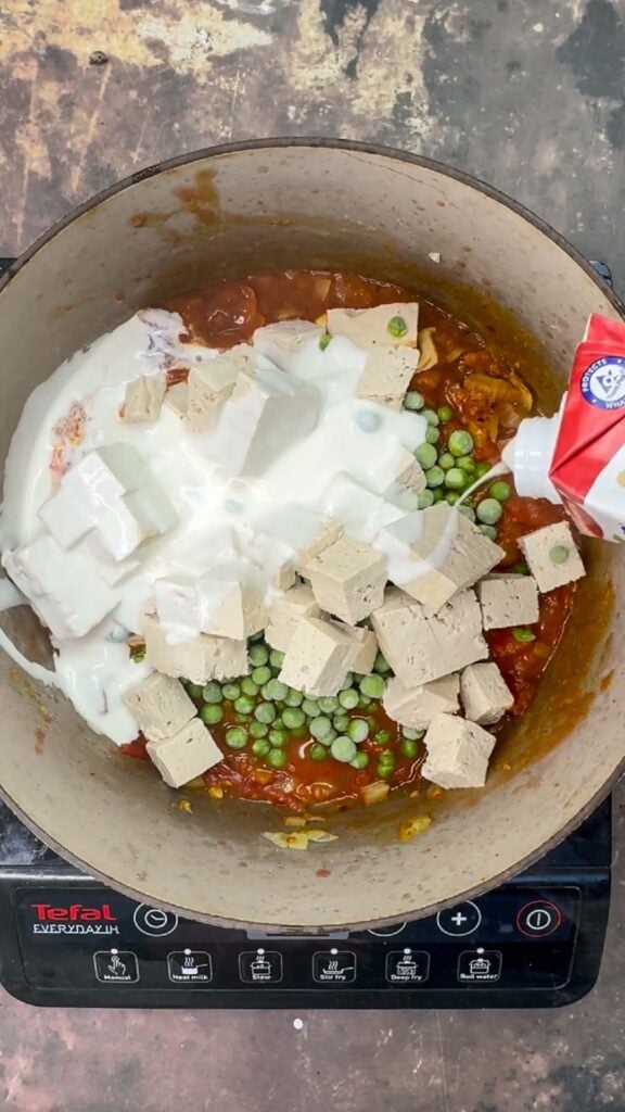 Adding creamed to matar paneer pan