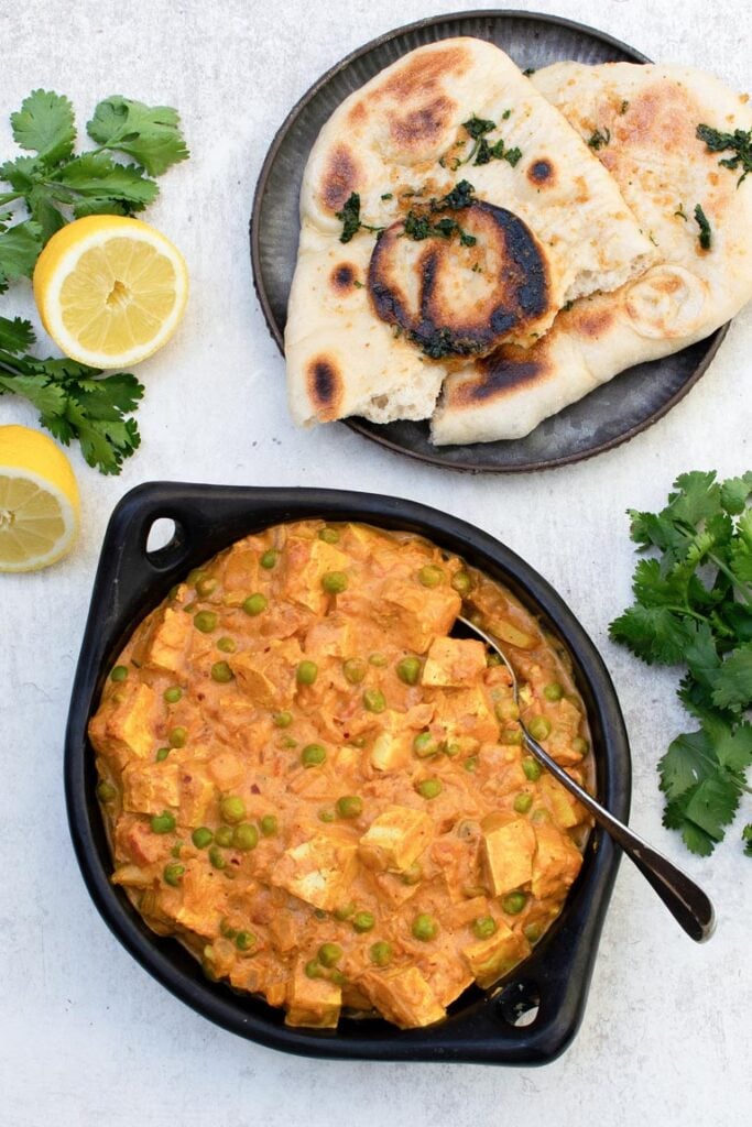 Creamy vegan matar paneer with tofu and frozen green peas in a rich tomato and garam masala sauce