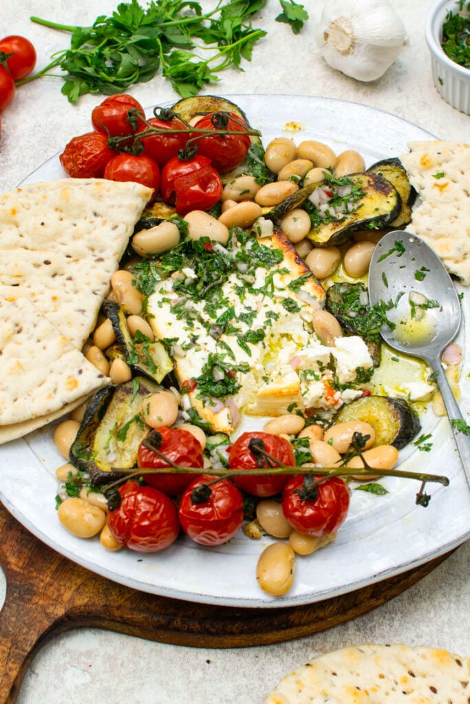 Creamy baked feta surrounded by roasted courgettes and cherry tomatoes