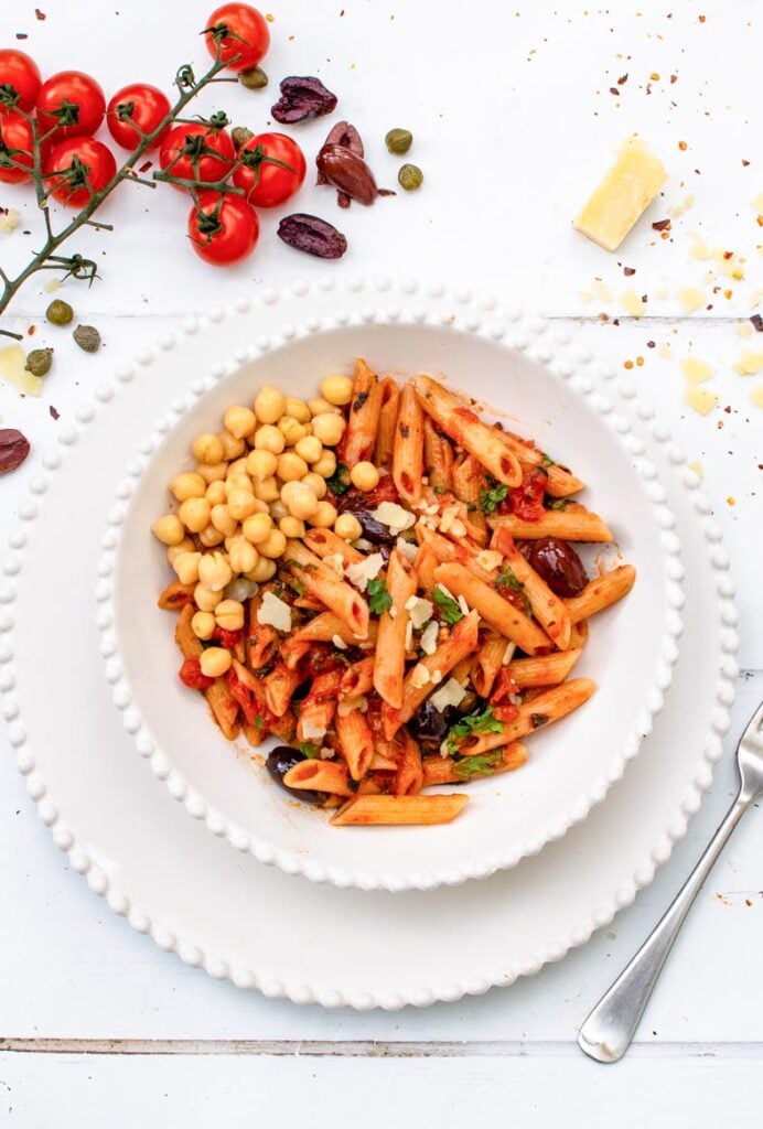 Vegan puttanesca pasta served with chickpeas, Kalamata olives, capers and fresh herbs