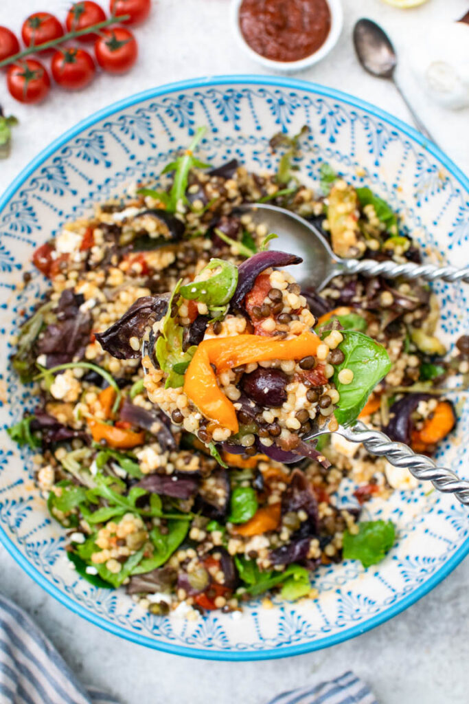 close up of Mediterranean pearl couscous salad with spoon