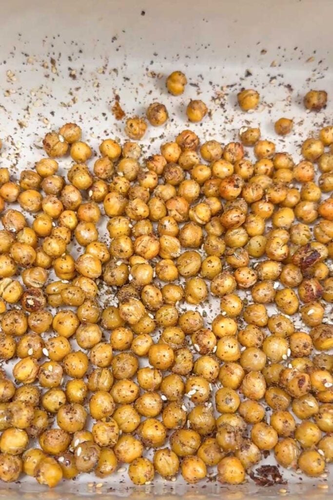 Golden-brown, crispy air-fried chickpeas coated in za'atar seasoning and sesame seeds in a single layer