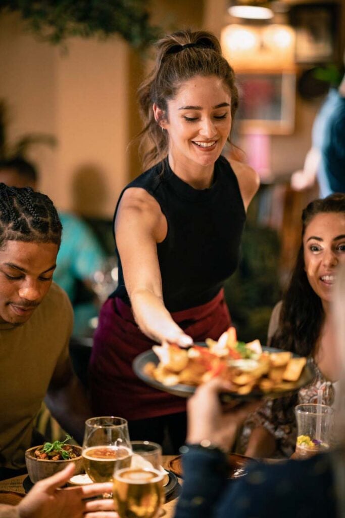 waitress serving food in a restaurant