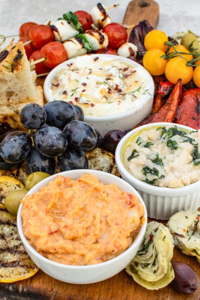 Finished antipasto platter arranged on a wooden board