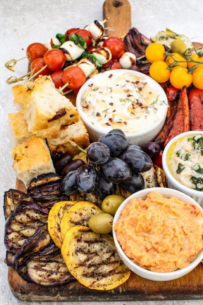 Close-up of an antipasto platter showing grilled aubergine, pepper and olives