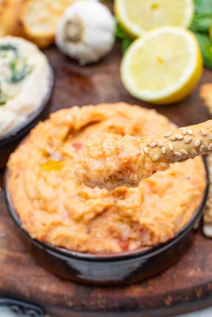 Close-up of smooth roasted pepper cannellini dip with breadstick
