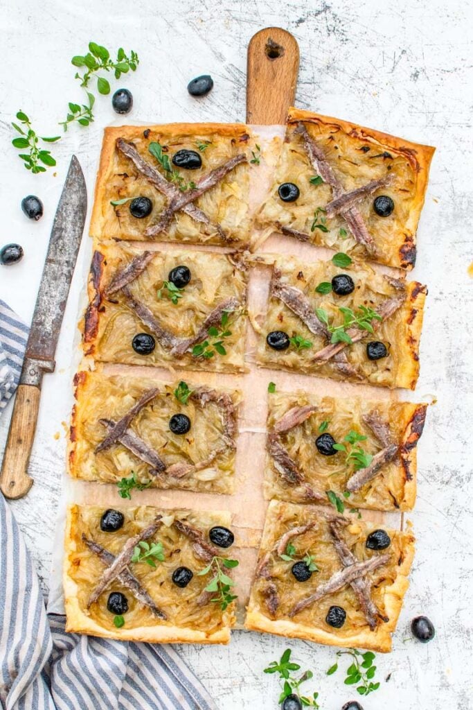 Close-up of pissaladière topped with black olives and anchovies