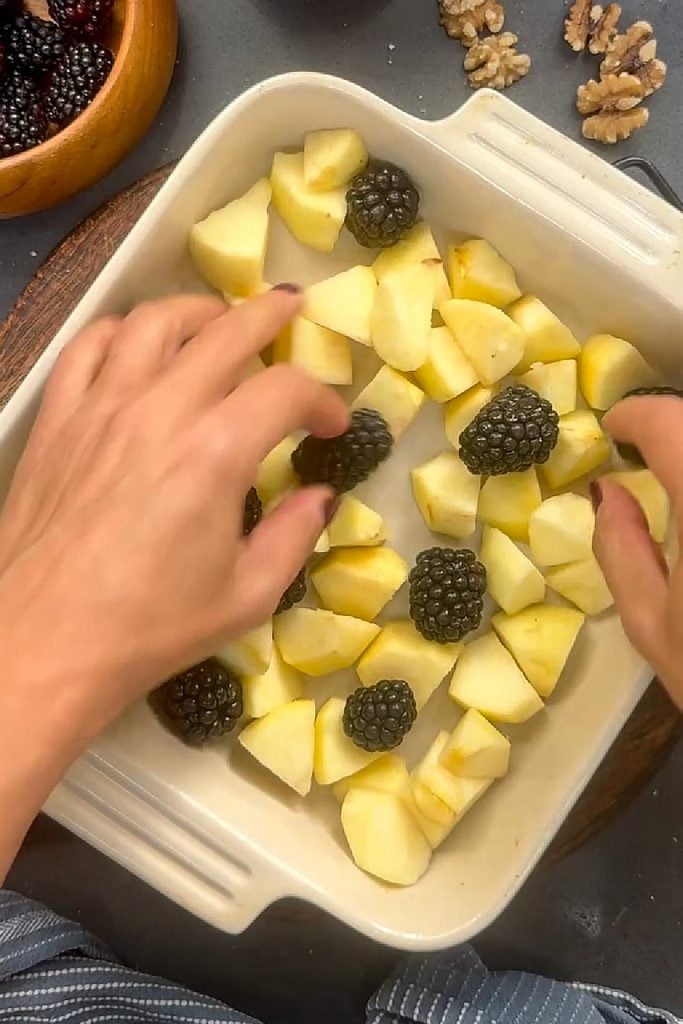 spreading apples and blackberry in oven proof dish