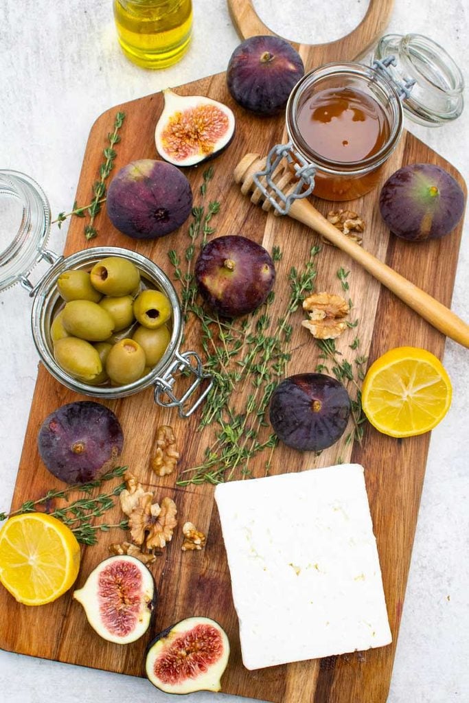 ingredients for Roasted Figs and Feta with Honey & Walnuts on wooden board