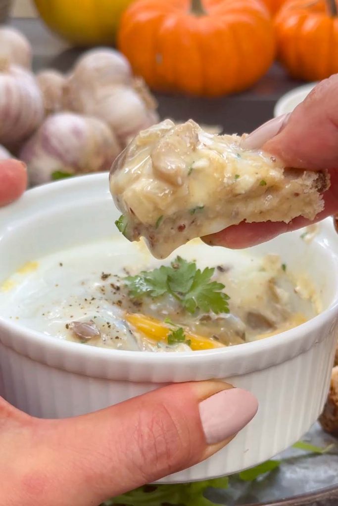 Toast soldier topped with creamy mushrooms lifted from a ramekin of oeufs en cocotte