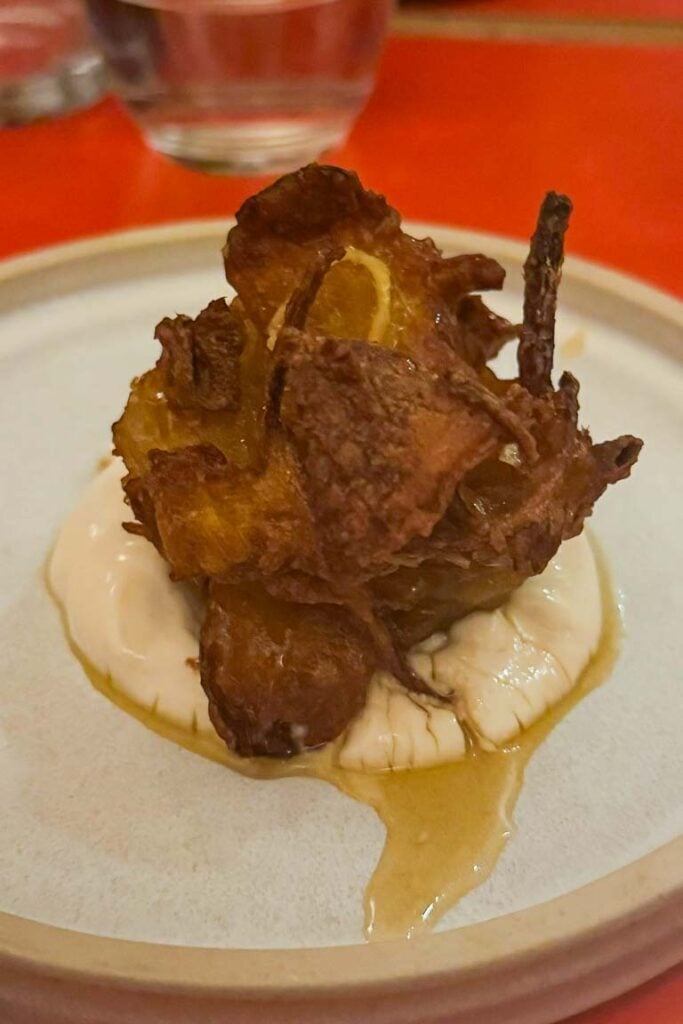 Delicata squash pakora on whipped ricotta drizzled with ginger-infused wild honey
